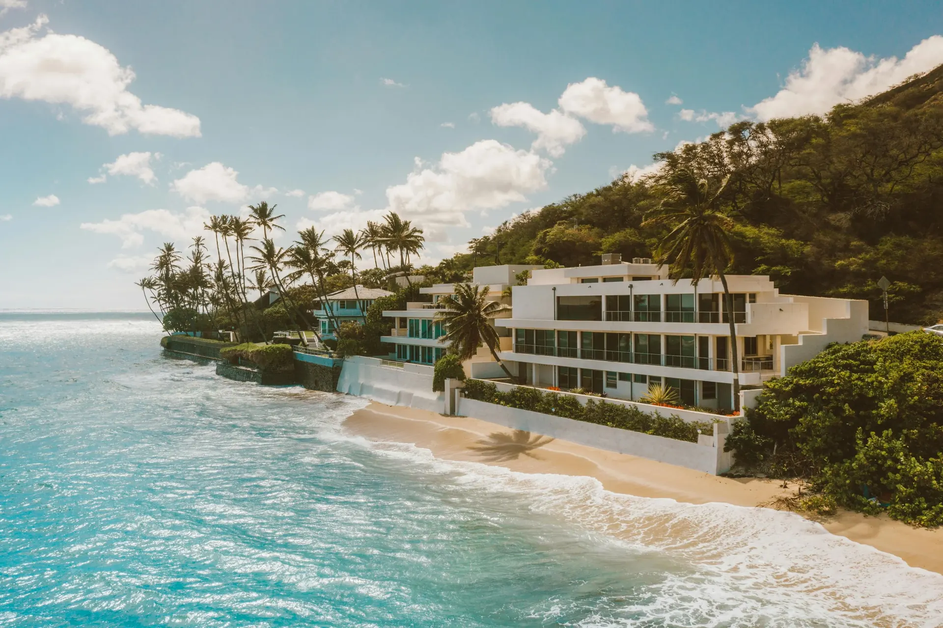 Aerial view of a South Florida waterfront luxury home at sunset